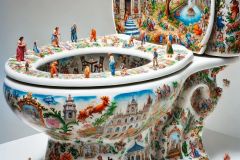 DALL·E-2025-09-02-20.59.57-A-photorealistic-close-up-of-a-white-porcelain-toilet-displayed-as-an-art-piece-its-entire-smooth-surface-painted-with-ornate-azulejos-style-designs