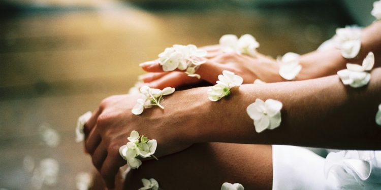 person surrounded by white flowers