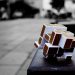 Artistic cube puzzle placed on a surface in an urban setting, capturing depth and focus.