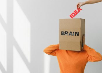 Surreal image of a person with a cardboard brain, symbolizing idea and intellect.