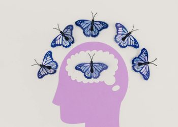 Creative illustration of butterflies representing thoughts over a brain silhouette.