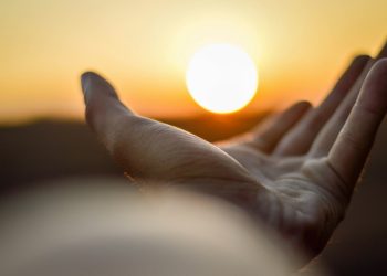 persons left hand on white textile