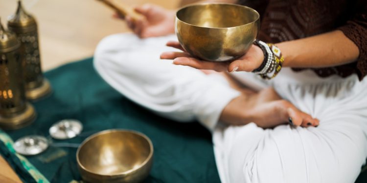 person in white dress shirt holding brown wooden chopsticks