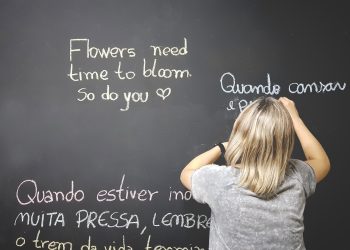 unknown person writing on chalkboard