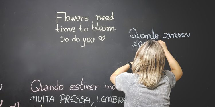 unknown person writing on chalkboard