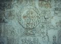 a close up of a stone wall with carvings on it