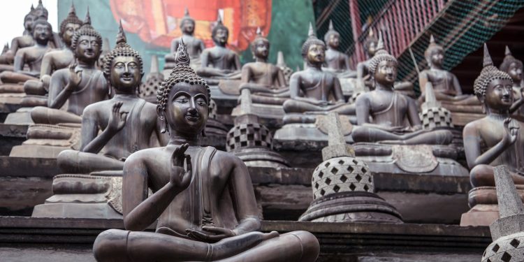 gold buddha statue on brown wooden table
