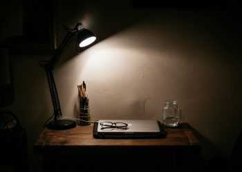 black desk lamp on brown wooden table