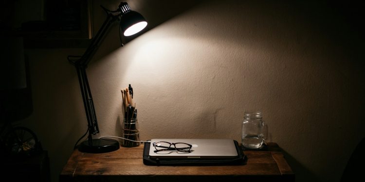 black desk lamp on brown wooden table