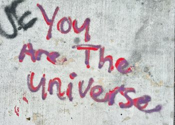 graffiti on a wall that says you are the universe