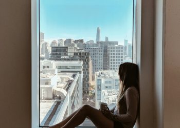 woman sitting beside window