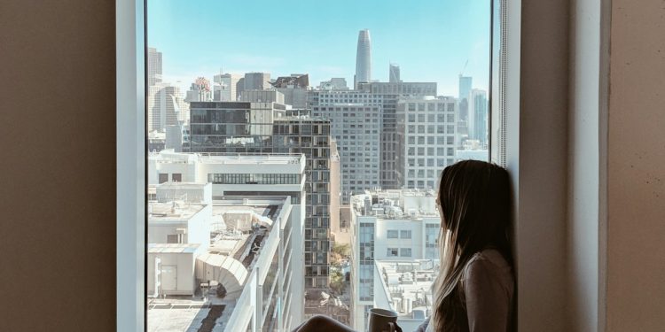 woman sitting beside window