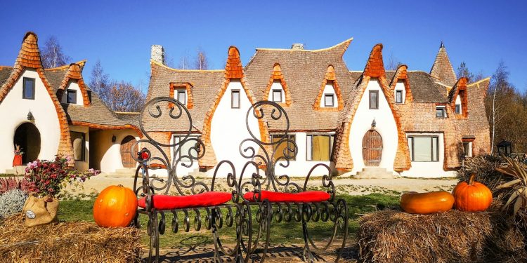 brown wooden bench near brown and white concrete house during daytime