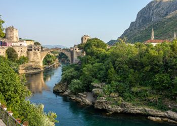 brown concrete bridge over river during daytime