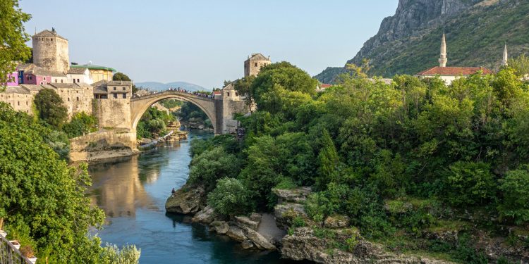 brown concrete bridge over river during daytime