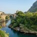 brown concrete bridge over river during daytime