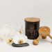 white and brown wooden spoon beside black ceramic mug