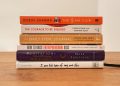 assorted books on brown wooden table