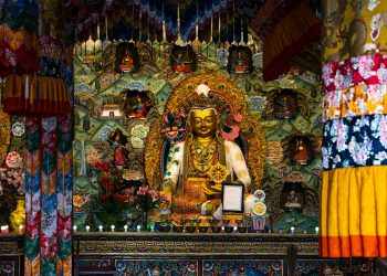 a shrine with a buddha statue in the middle of it