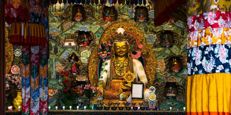 a shrine with a buddha statue in the middle of it