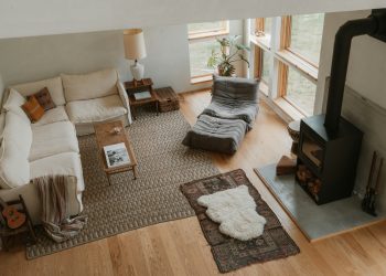 Cozy living room with sectional sofa and wood stove.