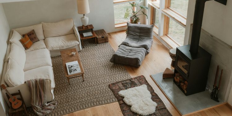 Cozy living room with sectional sofa and wood stove.
