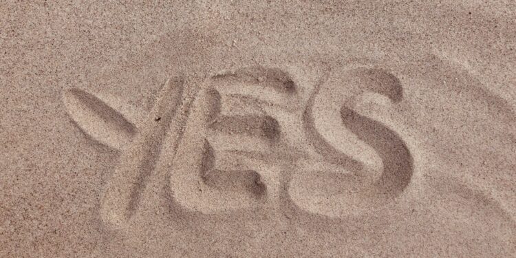 yes text on brown sand