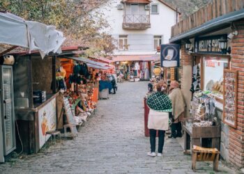 A man and woman walking down a street