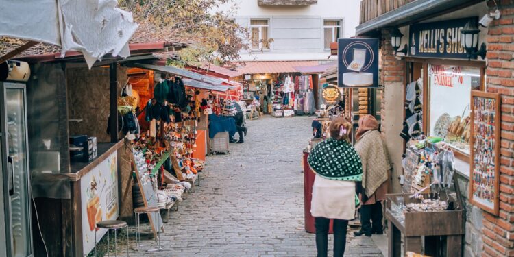 A man and woman walking down a street