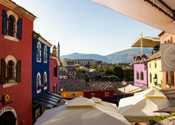 a group of buildings with tents in front of them
