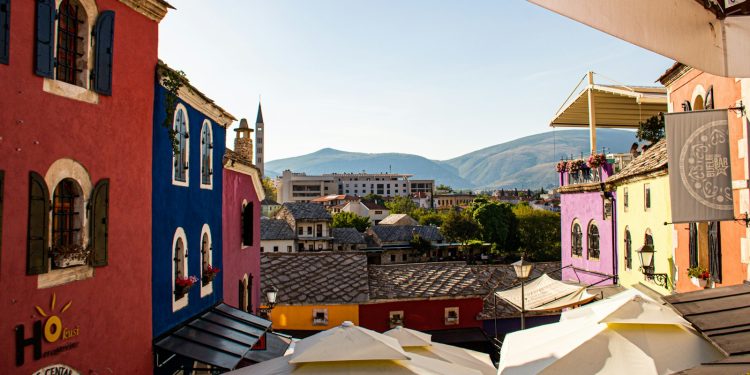 a group of buildings with tents in front of them