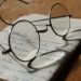 silver-colored framed eyeglasses on white printer paper