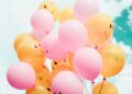 low-angle photo of pink and orange balloons