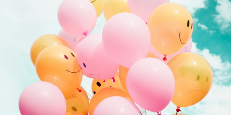 low-angle photo of pink and orange balloons