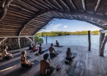 a group of people sitting on top of a wooden floor