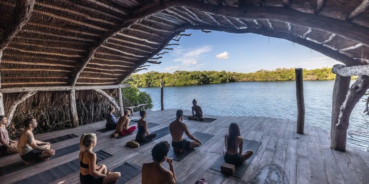 a group of people sitting on top of a wooden floor