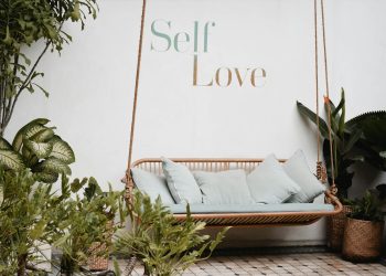 brown rattan swing bench with cushions