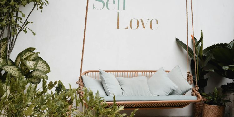 brown rattan swing bench with cushions