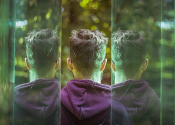 a couple of young men standing next to each other