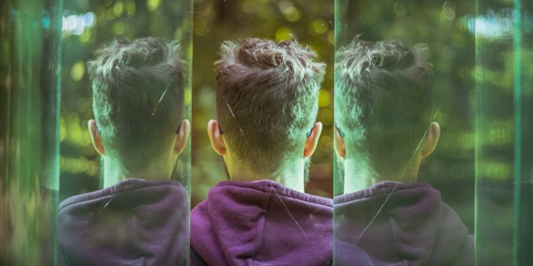 a couple of young men standing next to each other