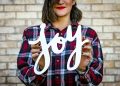 woman holding joy text