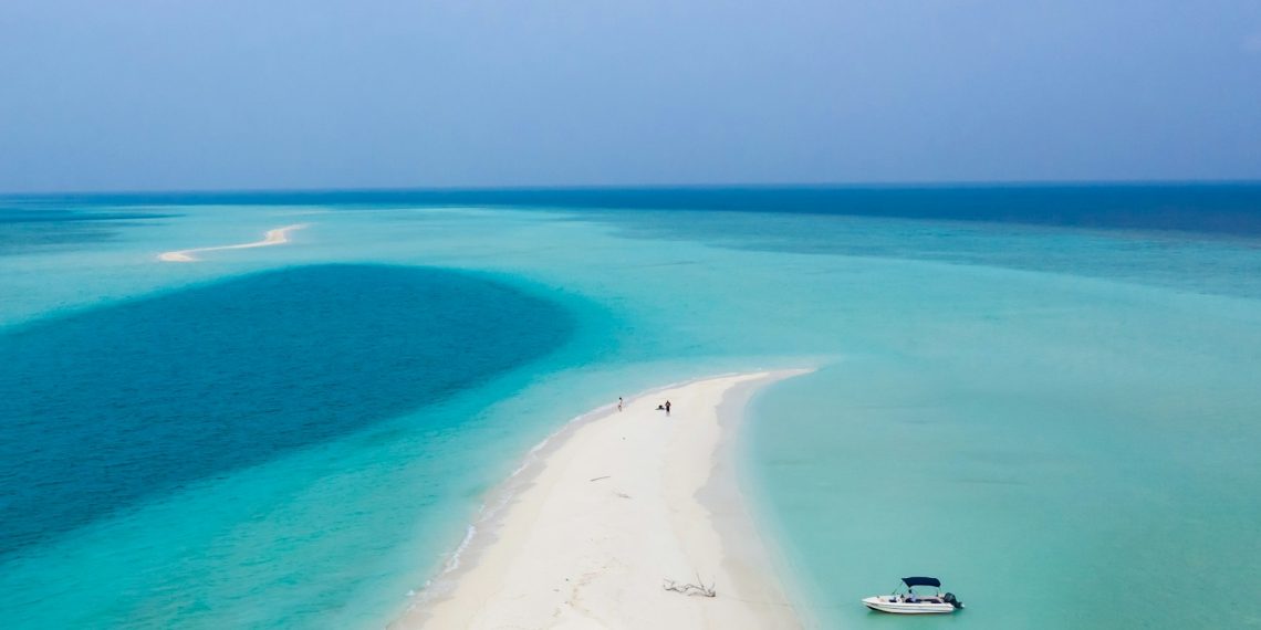 white boat on blue sea water during daytime
