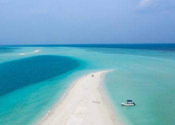 white boat on blue sea water during daytime