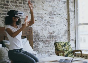 Woman wearing vr headset interacting with virtual reality