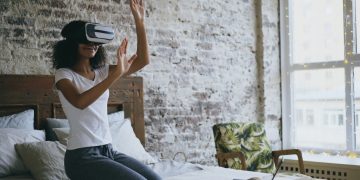 Woman wearing vr headset interacting with virtual reality