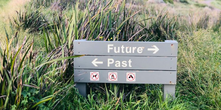 a sign in the middle of a grassy field