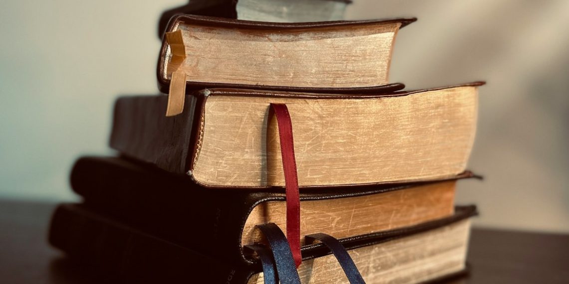 a stack of books sitting on top of a table