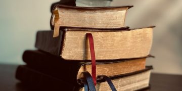 a stack of books sitting on top of a table
