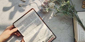 person holding white printer paper
