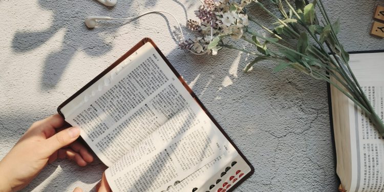 person holding white printer paper